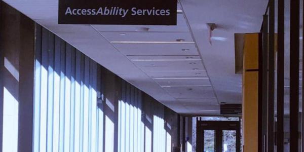 A hallway sign that reads "AccessAbility Services".